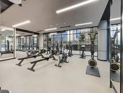 a gym with treadmills and cardio equipment in a building at 1BR with Direct Burj Khalifa View in Dubai