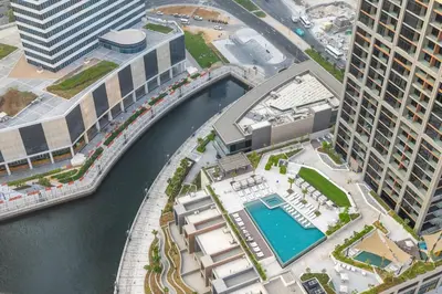 an overhead view of a river between two tall buildings at 1BR with Direct Burj Khalifa View in Dubai