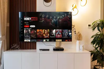 a flat screen tv sitting on top of a white cabinet at Stylish 1-Bedroom with Lake View in Business Bay in Dubai