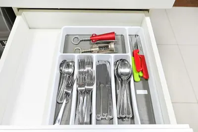 a drawer filled with silver utensils in a cabinet at Fantastic 2 Bed - Marina in Dubai