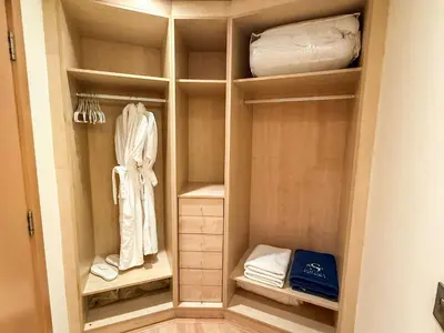 a walk in closet with white clothes and towels at Sea View Beachfront 3BR Apartment - Shoreline 6 in Dubai