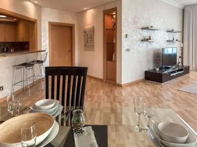a dining room with a table and a television at Sea View Beachfront 3BR Apartment - Shoreline 6 in Dubai