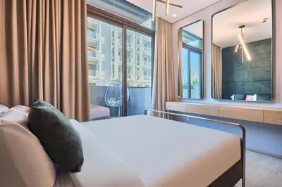 a hotel room with a bed and a window at Modern Studio Elegant & Comfort in Dubai