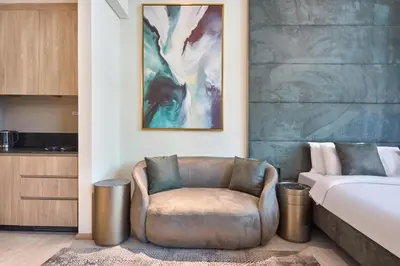 a bedroom with a chair next to a bed at Modern Studio Elegant & Comfort in Dubai