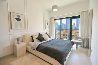 a bedroom with a bed and a large window at Full Burj Khalifa View, 3min Walk to Dubai Mall in Dubai