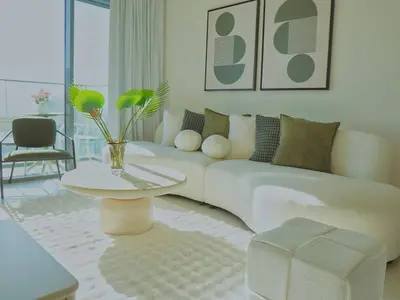 a living room with a white couch and a table at Stylish-2BR, Burj Royale, 3 min walk to Dubai Mall in Dubai