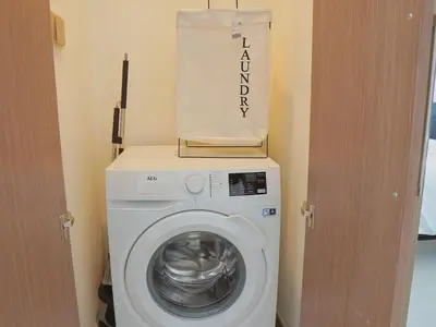 a washing machine with a bag on top of it at Stylish-2BR, Burj Royale, 3 min walk to Dubai Mall in Dubai