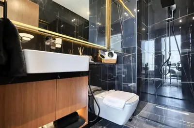 a bathroom with a toilet and a sink and a shower at High Rise Studio Pool Gym Binghatti Gardenia JVC in Dubai