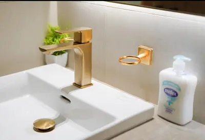 a bathroom sink with a faucet and a bottle of soap at High Rise Studio Pool Gym Binghatti Gardenia JVC in Dubai