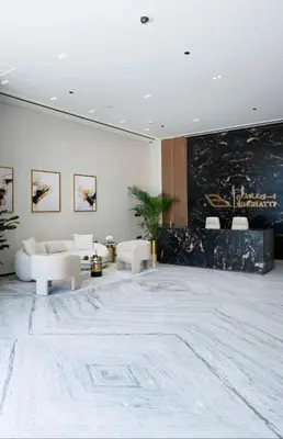a living room with white furniture and a large rug at High Rise Studio Pool Gym Binghatti Gardenia JVC in Dubai
