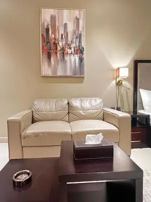 a living room with a couch and a table at Cozy Spacious Studio in Downtown with Burj Khalifa View in Dubai
