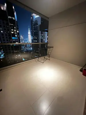 a balcony with a view of a city at night at Cozy Spacious Studio in Downtown with Burj Khalifa View in Dubai