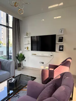 a living room with a couch and a tv at RIVIERA HOME ESCAPE 2BHK pool Gym in Dubai