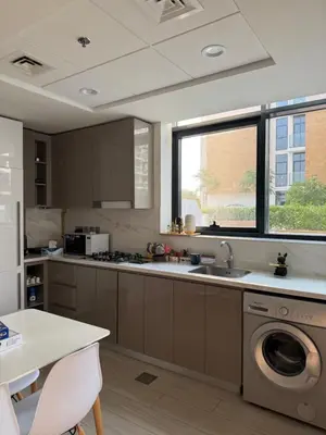 a kitchen with a sink and a washing machine at RIVIERA HOME ESCAPE 2BHK pool Gym in Dubai