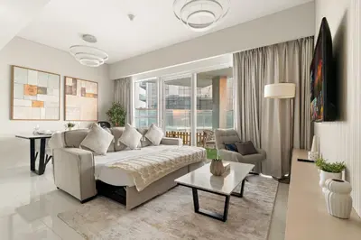 a living room with a couch and a table at Spacious 1BR with Huge Terrace in Dubai