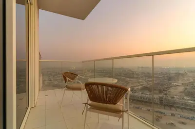 a room with a table and chairs on a balcony at Spacious 1BR with Huge Terrace in Dubai