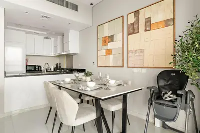 a kitchen and dining room with a table and chairs at Spacious 1BR with Huge Terrace in Dubai
