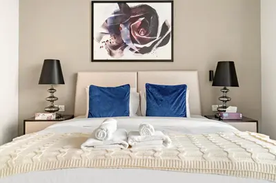 a bedroom with a bed with two towels on it at Spacious 1BR with Huge Terrace in Dubai