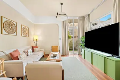a living room with a large flat screen tv at FIRST CLASS VILLA Modern Comfort & Style in Dubai