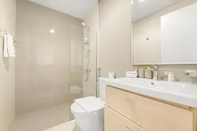 a bathroom with a sink and a toilet and a shower at FIRST CLASS VILLA Modern Comfort & Style in Dubai