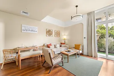 a living room with a couch and a table at FIRST CLASS VILLA Modern Comfort & Style in Dubai
