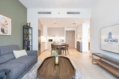 a living room with a couch and a table at Premium Creek Home Steps from the Lagoon in Dubai