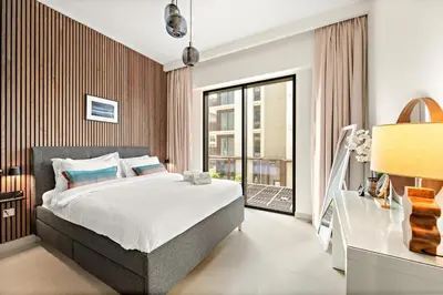a bedroom with a bed and a large window at FIRST CLASS 1BR Creek Beach , Relaxing Vibes in Dubai