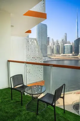 two chairs and a table on a balcony with a view of the city at Business Bay 1BR Burj Khalifa&Canal Views,3Balcony in Dubai