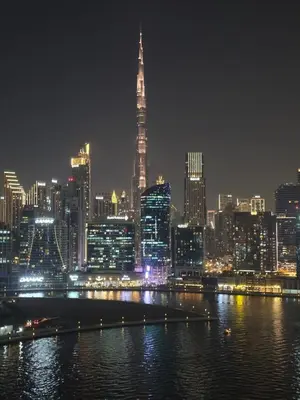 a view of a city skyline at night at Business Bay 1BR Burj Khalifa&Canal Views,3Balcony in Dubai