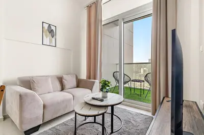 a living room with a couch and a table at FIRST CLASS 1BR Canal View Escape in Dubai