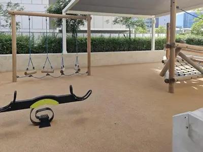 a seesaw and swings in a playground at FIRST CLASS 1BR Canal View Escape in Dubai