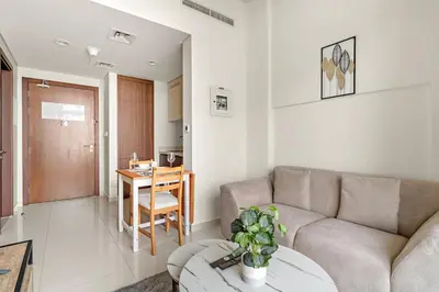 a living room with a couch and a table at FIRST CLASS 1BR Canal View Escape in Dubai