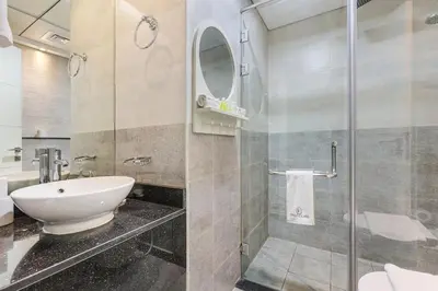 a bathroom with a shower and a toilet and a sink at FIRST CLASS Studio Stylish & Cozy JVC Escape in Dubai