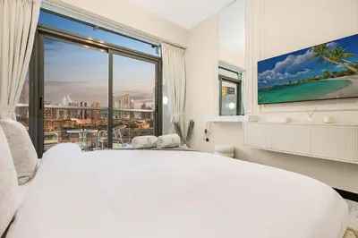 a bedroom with a large white bed and a large window at FIRST CLASS Studio Stylish & Cozy JVC Escape in Dubai