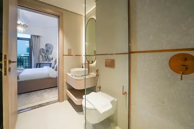 a bathroom with a toilet and a sink and a shower at EasyGo - Modern 1BR with Balcony & Amenities in Arjan in Dubai