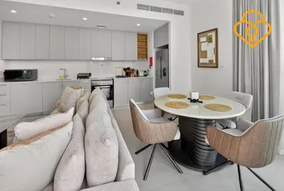 a living room with a couch and a table with chairs at Keysplease Beautiful 2 BR Creek Crescent Water View, Harbour in Dubai