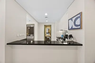 a kitchen with a black counter top in a room at Paramount Midtown, Luxury 1BR with Infinity Pool with Burj View in Dubai