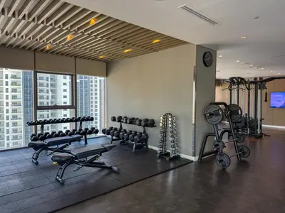 a gym with several treadmills and exercise bikes at Paramount Midtown, Luxury 1BR with Infinity Pool with Burj View in Dubai