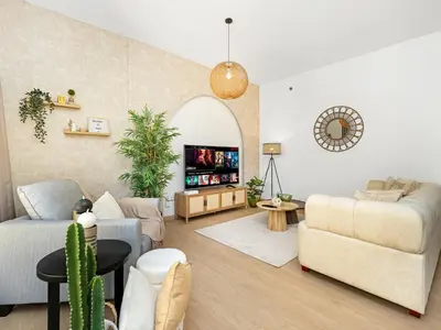 a living room with a couch and a table at Beachfront 2BR Dubai Eye & Sea View Beach Access in Dubai