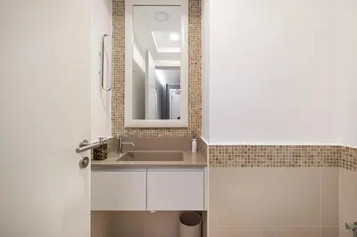 a bathroom with a sink and a mirror at Spacious Apartment with Excellent Facilities in Dubai