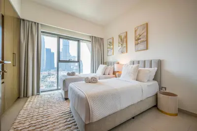 two beds in a hotel room with a large window at Stunning Burj Khalifa View! Steps to Dubai Mall in Dubai