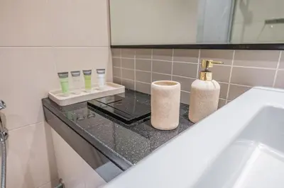 a bathroom counter with two rolls of toiletries on it at Dubai Marina Skyline with Sunset and Sunrise View in Dubai