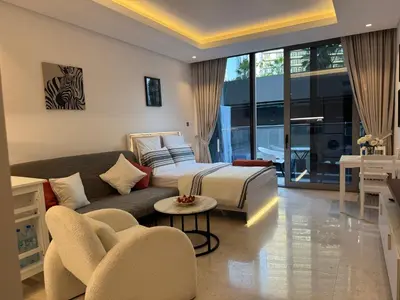 a bedroom with a bed and a couch at The Sterling 4 sleep with AC parking and pool in Dubai