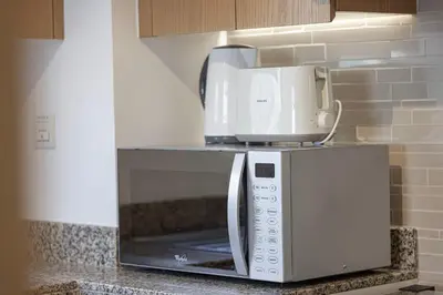 a coffeemaker sitting on top of a microwave at Sanctuary Stays - Premium 1BR - Burj Khalifa Views - Near Dubai Mall in Dubai