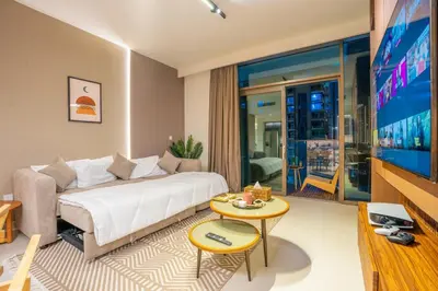 a living room with a couch and a tv at Luxury 2BR at Burj Crown Sleeps 7 PS5 & 65-inch TV in Dubai
