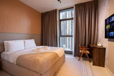 a hotel room with a bed and a large window at Luxury 2BR at Burj Crown Sleeps 7 PS5 & 65-inch TV in Dubai