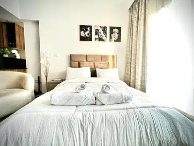 a bedroom with a bed with two towels on it at Spacious Modern Studio In downtown in Dubai