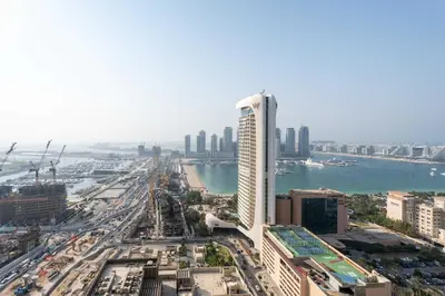 an aerial view of a city with a tall building at Luxury Renovated 1BR w Full Sea View in Dubai