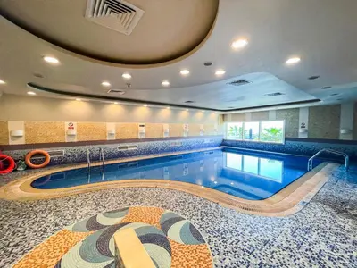 a pool in a building with a swimming pool at harborfront elegance dubai in Dubai