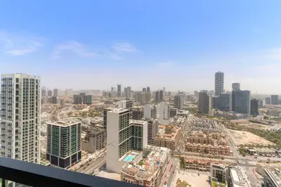 an aerial view of a city with tall buildings at VayK - Modern 2BD Retreat with Private Pool in JVC in Dubai